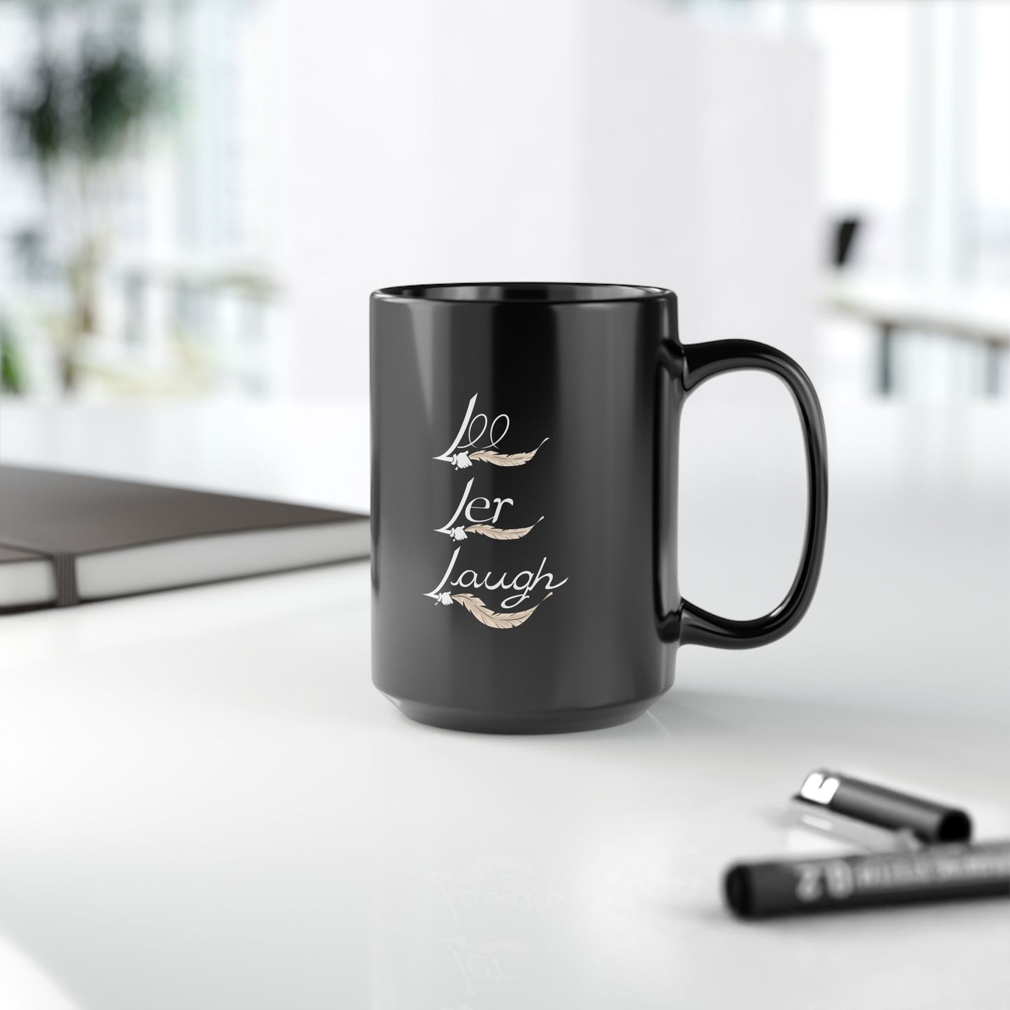 A pair of black ceramic mugs with unique designs on each side. One mug features a tickle fetish cartoon character with large tickling feathered wings, wearing red sneakers and holding a steaming cup of tea, with the words "T-Time" above it. The other mug showcases the phrase "Lee Ler Laugh" written. The mugs have a glossy finish and a sturdy handle, giving them a sleek and stylish appearance for tickling kink.